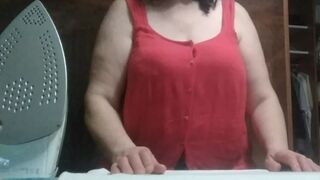 Stepmom, 57 years old, with Big Natural Tits, irons clothes and has a secret video call with her Stepson.